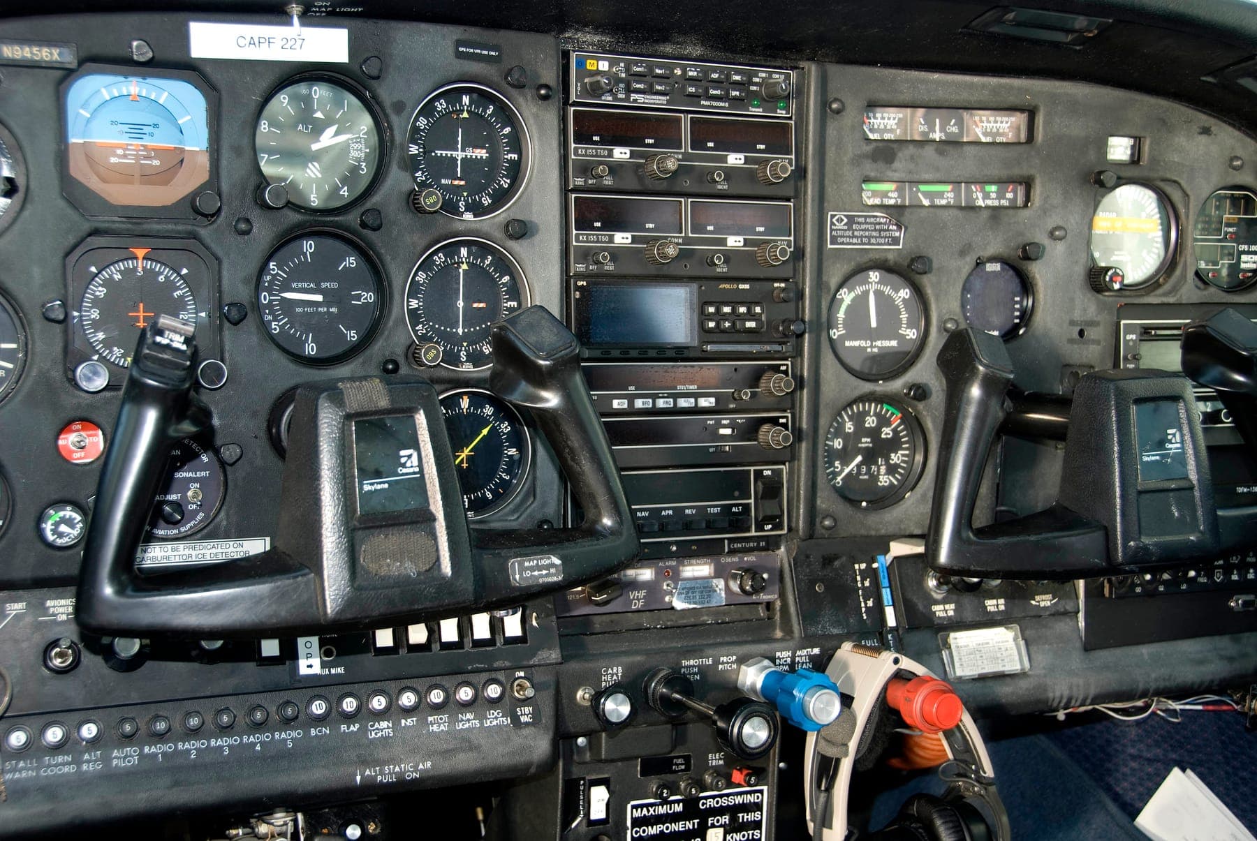 The instrument panel of a Cessna: the six flight instruments on the left, the radios in the middle and the control wheels in front.